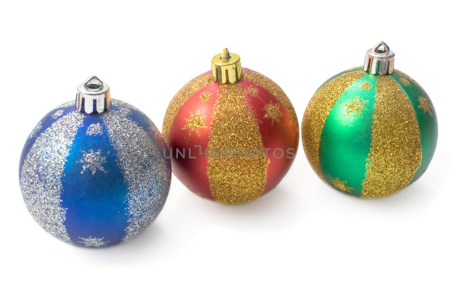 Three multi-coloured fur-tree spheres with spangles on a white background