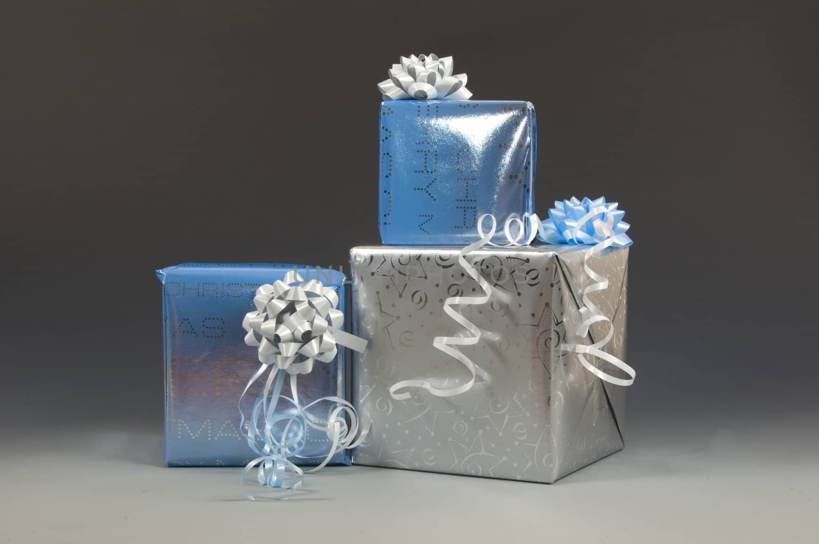 blue and silver christmas presents on a creme gray background
