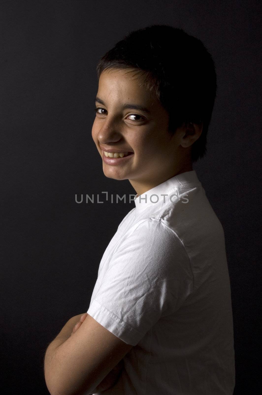 teenage boy is smiling on a black background