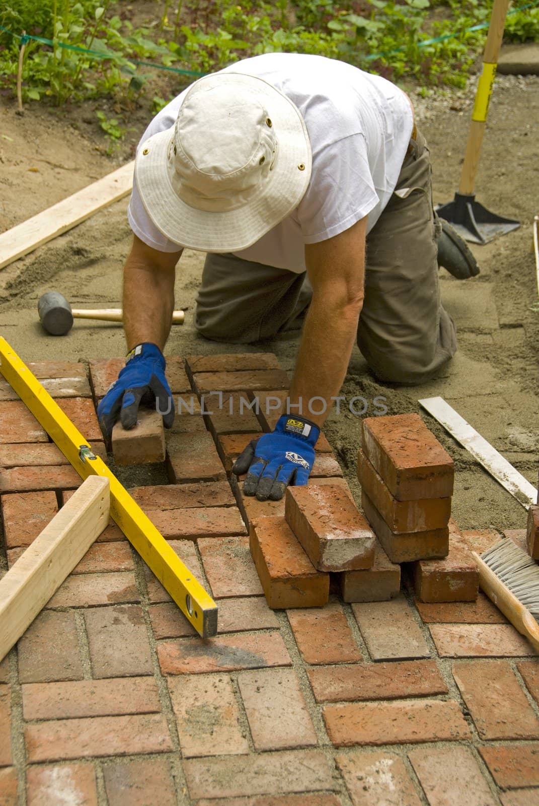 man laying a brick patio