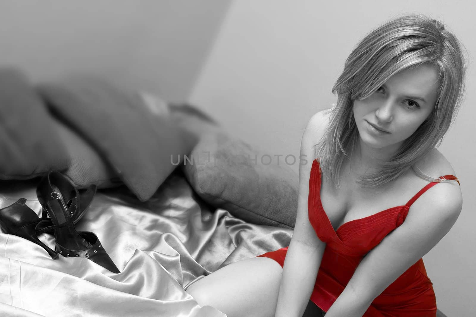 pretty girl is sitting on bed, black, white, red photo