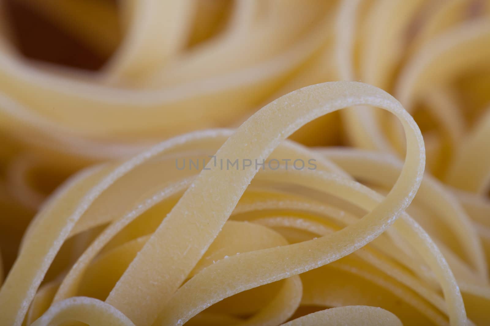 closeup of tagliatelli pasta on a wooden board
