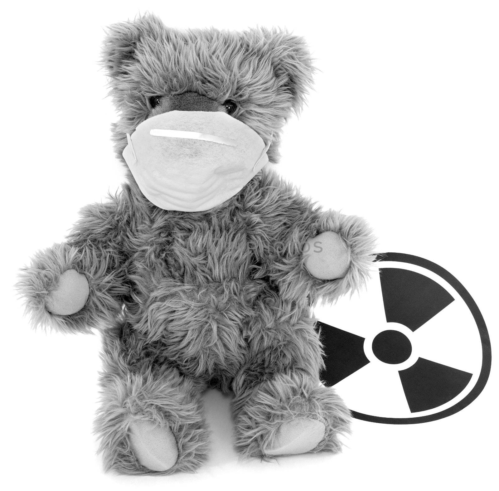 Toy brown baer in respirator and sign to radiation