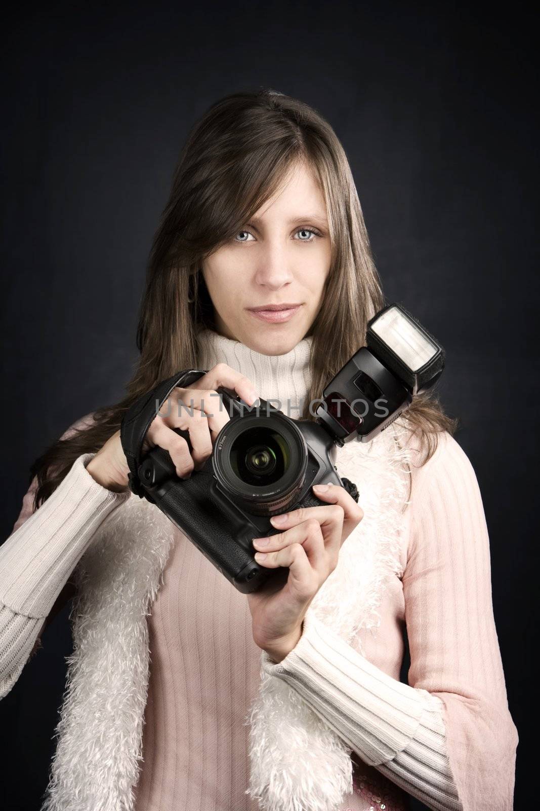 Pretty photographer with a professional camera and flash