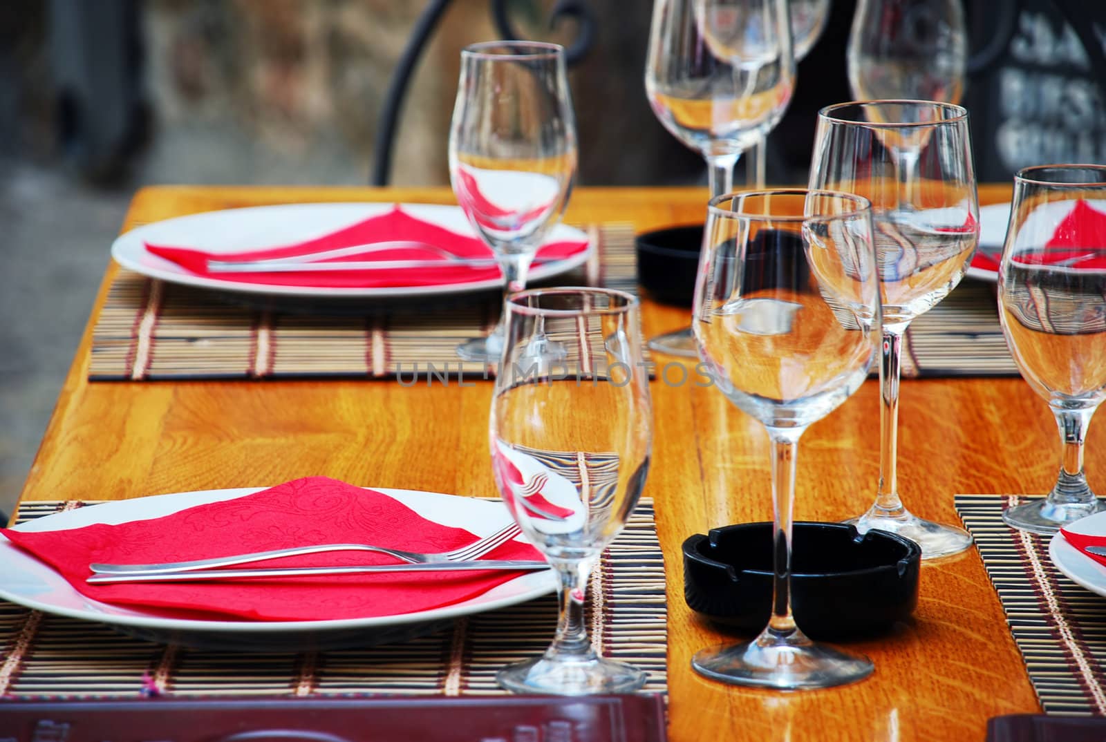 wineglasses and plates on table in restaurant
