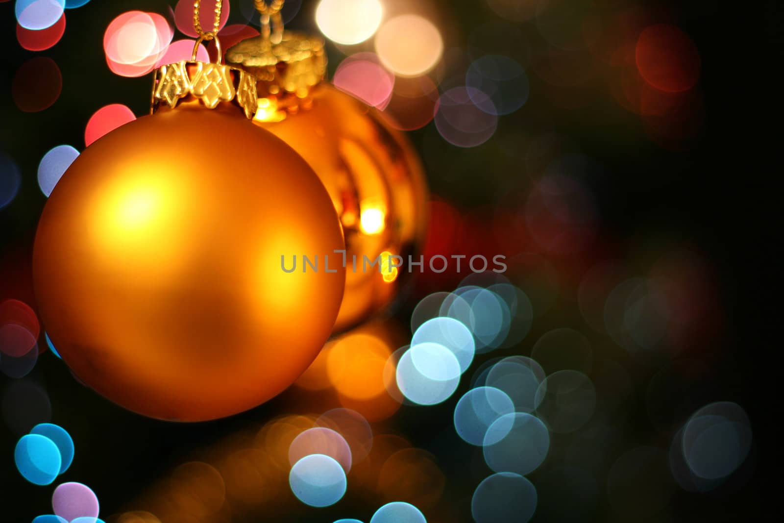 christmas balls hanging in front of the christmas tree
