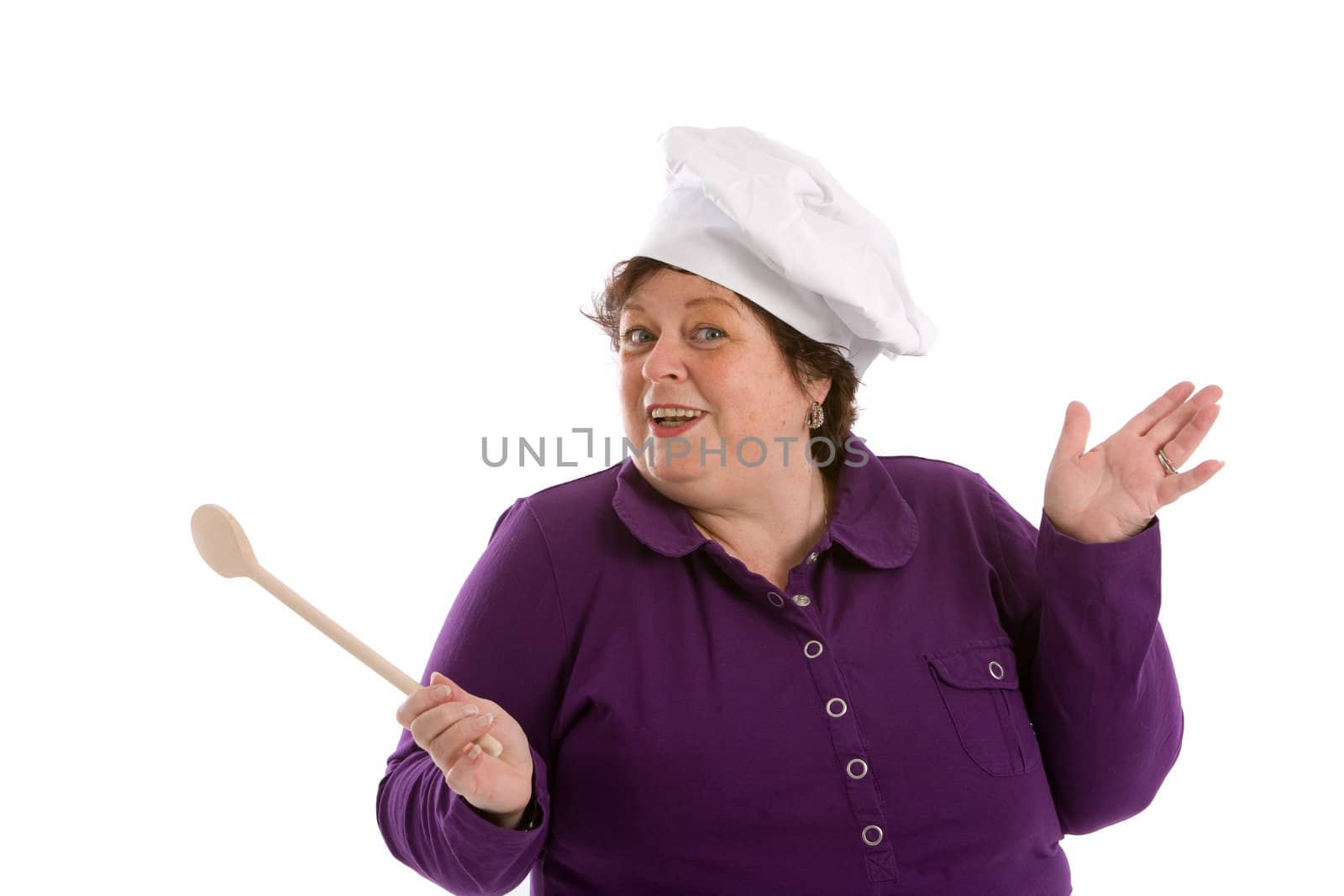 Middle aged woman waving her wooden spoon on white background