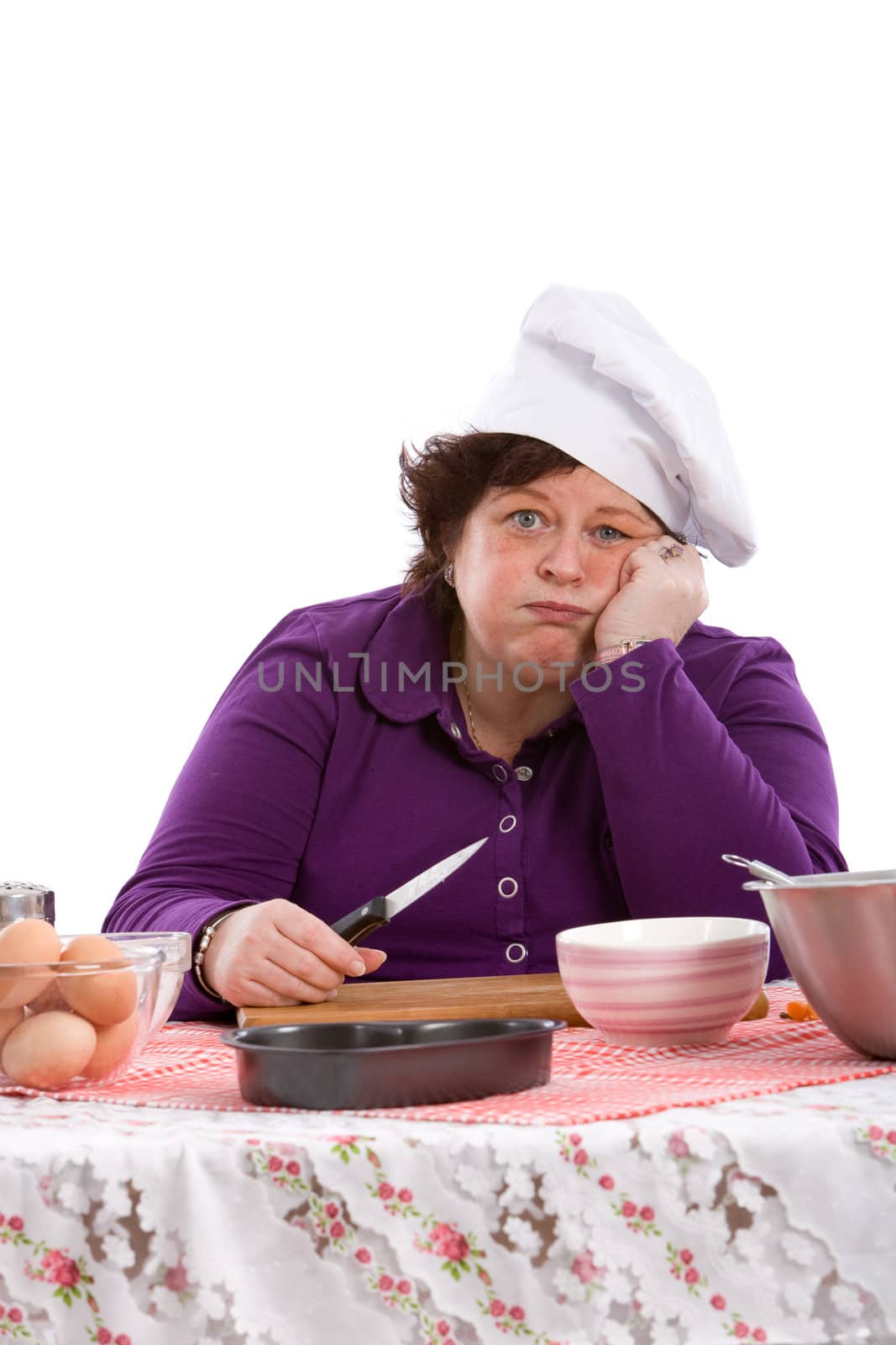 Mature woman leaning on her hand very tired after cooking