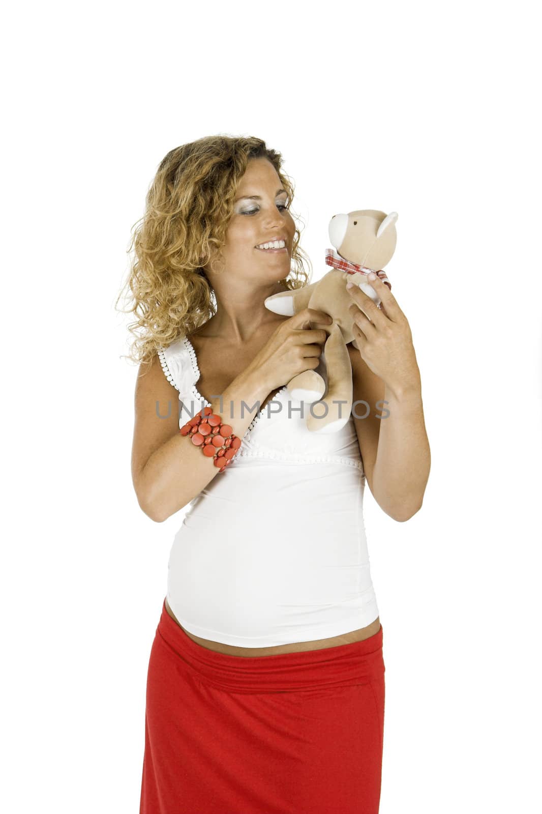 Beautiful pregnant woman with a teddy bear, isolated on white background 
