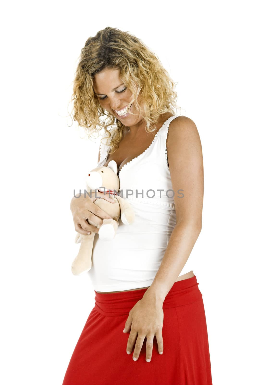 Beautiful pregnant woman with a teddy bear, isolated on white background 
