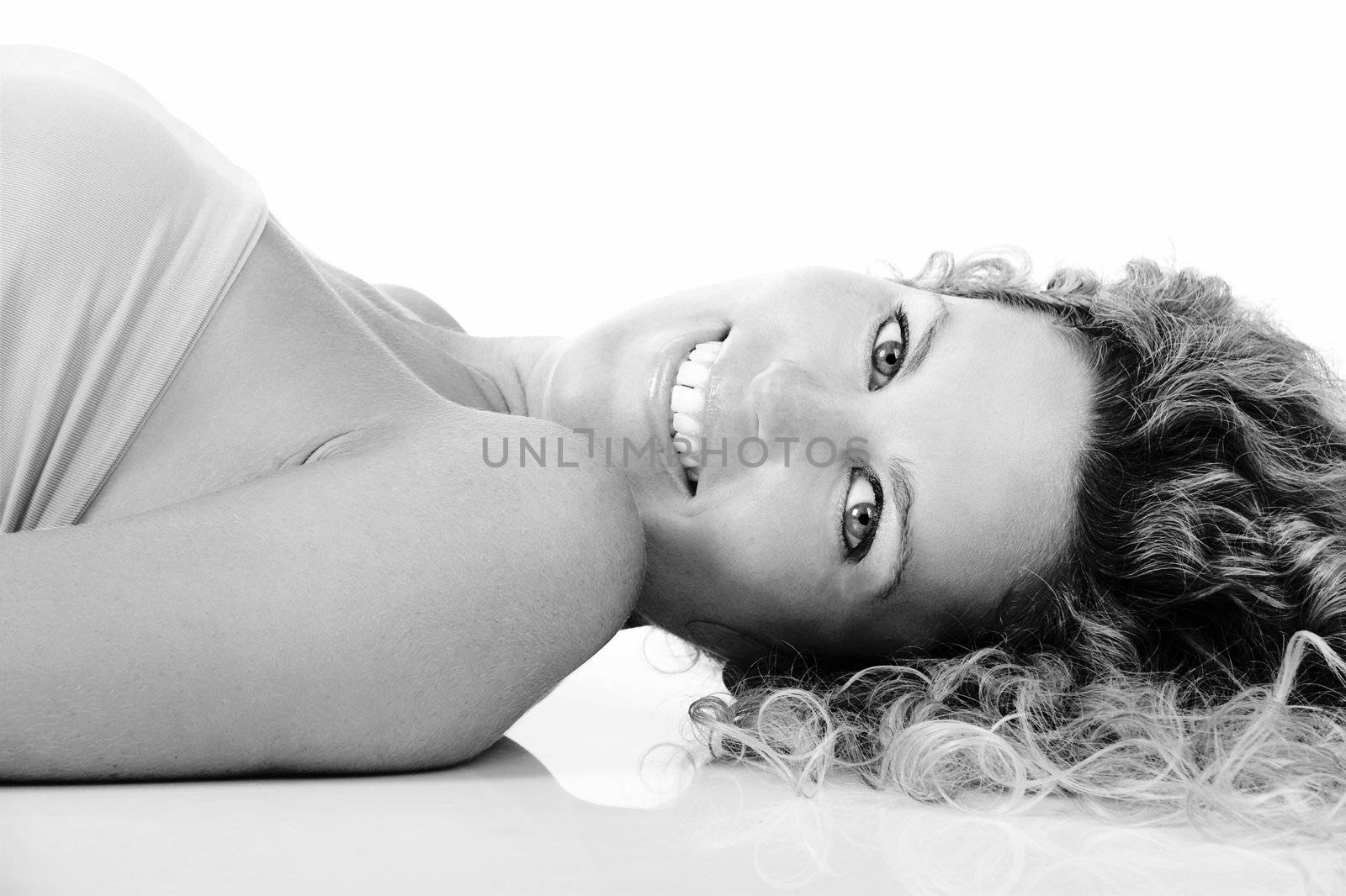 Beautiful blond woman portrait lying on the ground