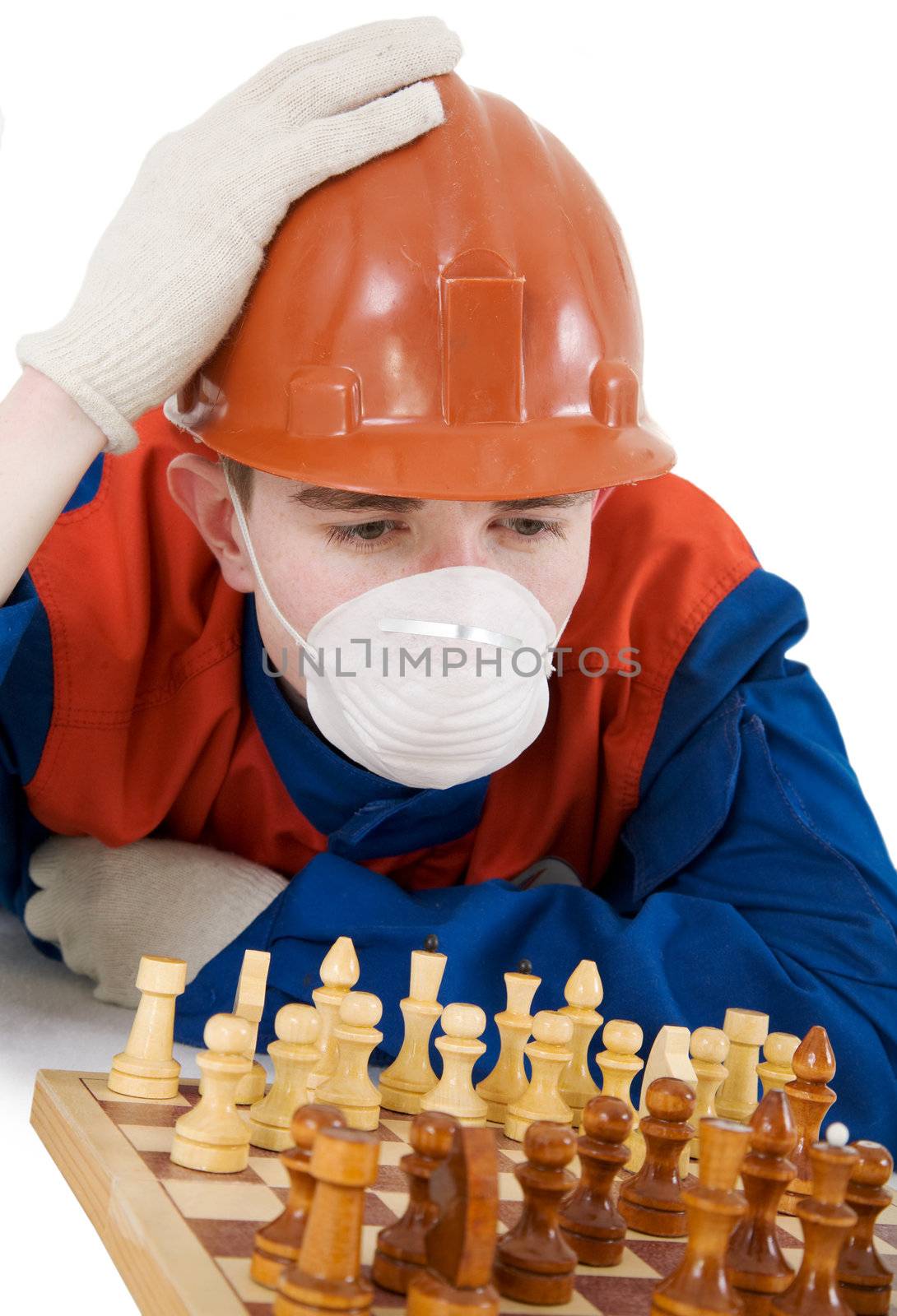 Labourer on the helmet and respirator with chess on a white background