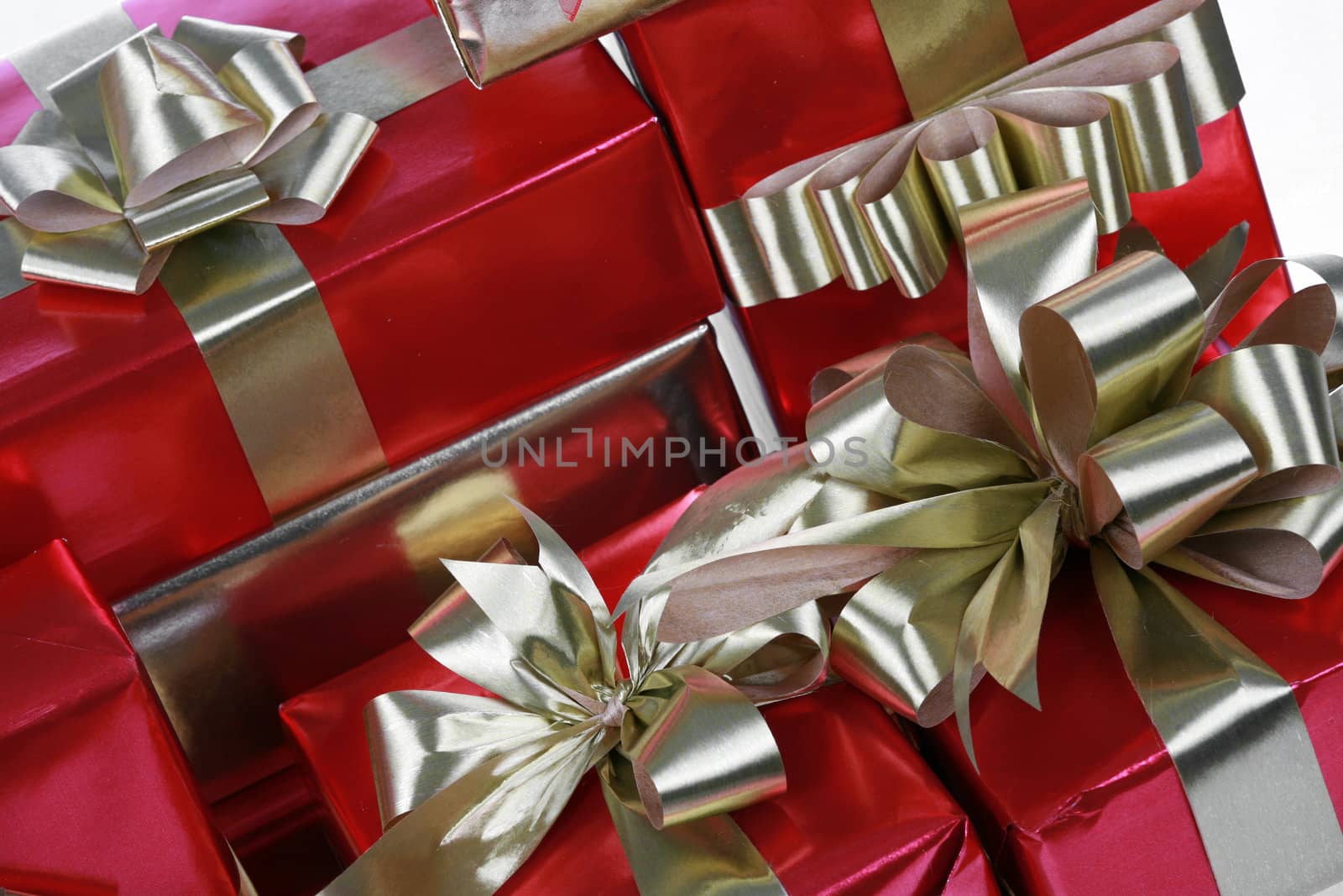 Elegant red presents with gold ribbons isolated on white