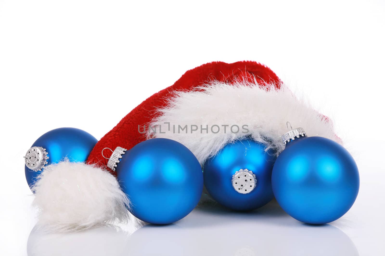 Red Santa hat with blue ornaments isolated on white