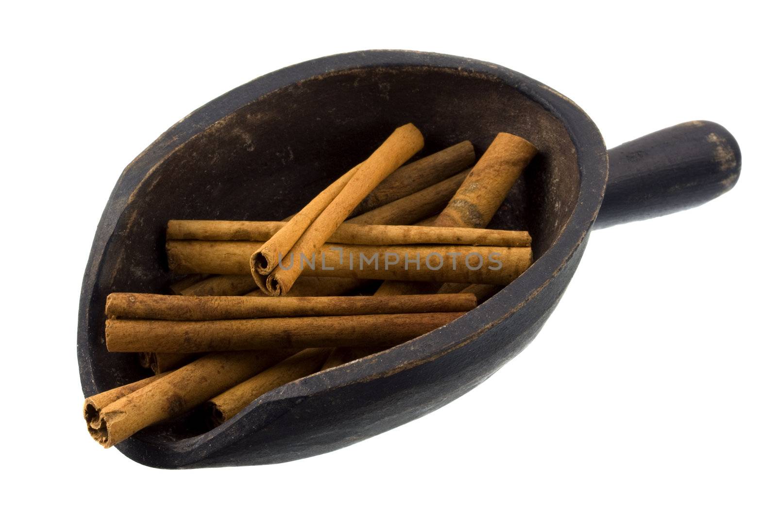 cinammon sticks on a rustic, wooden scoop, isolated on white