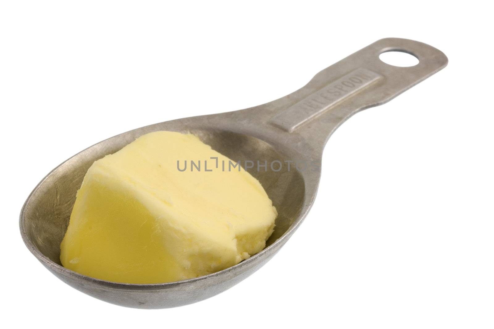 butter on measuring, aluminum spoon isolated with clipping path