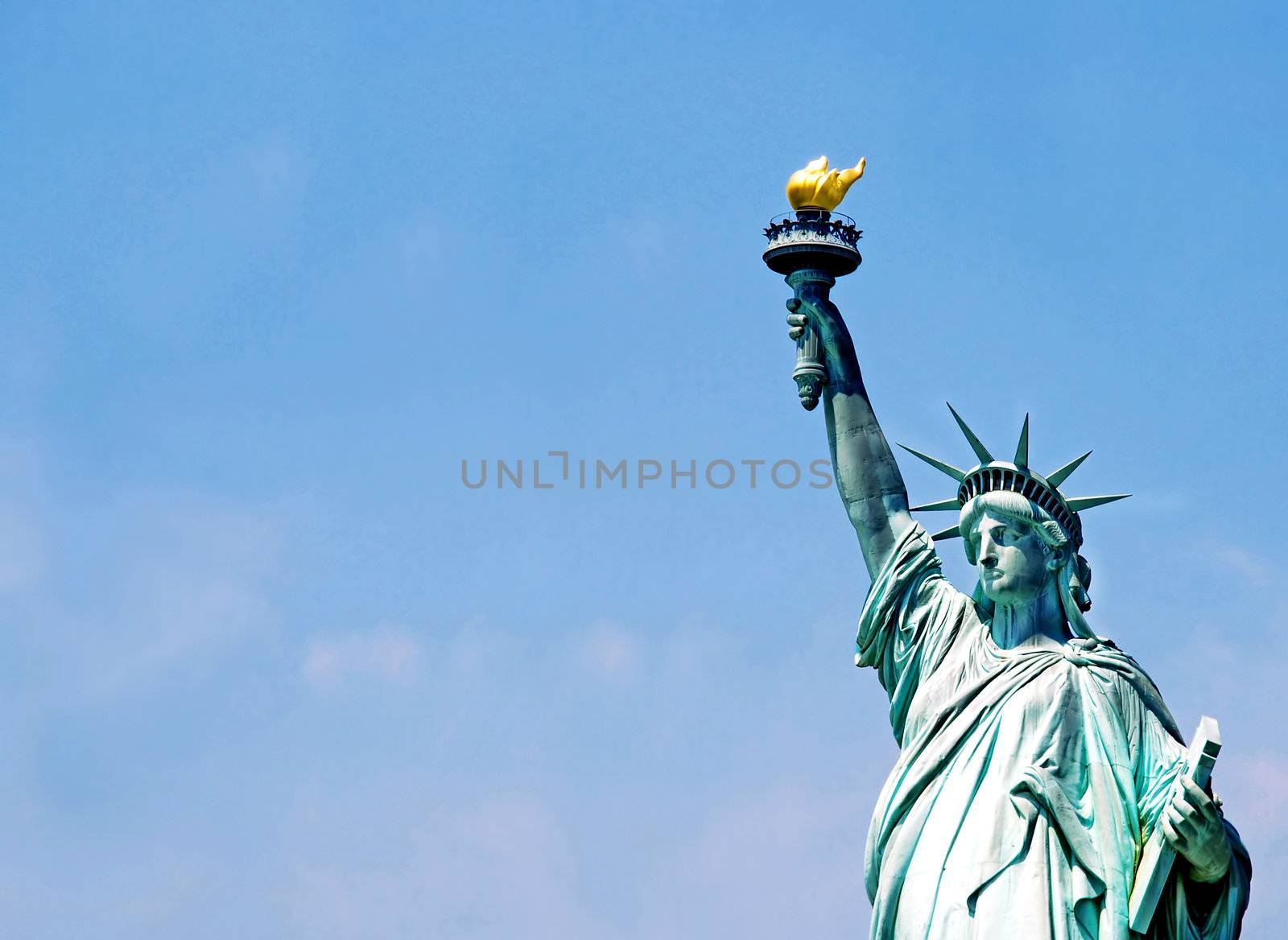 Statue of Liberty fragment over blue sky