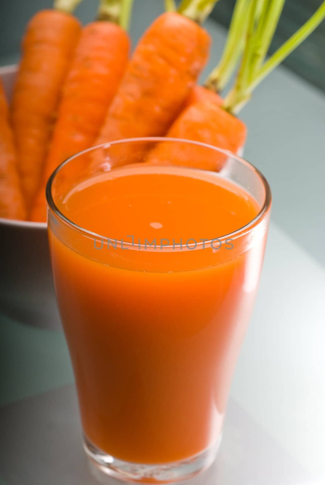 fresh and healty carrot juice unfiltered over a light table