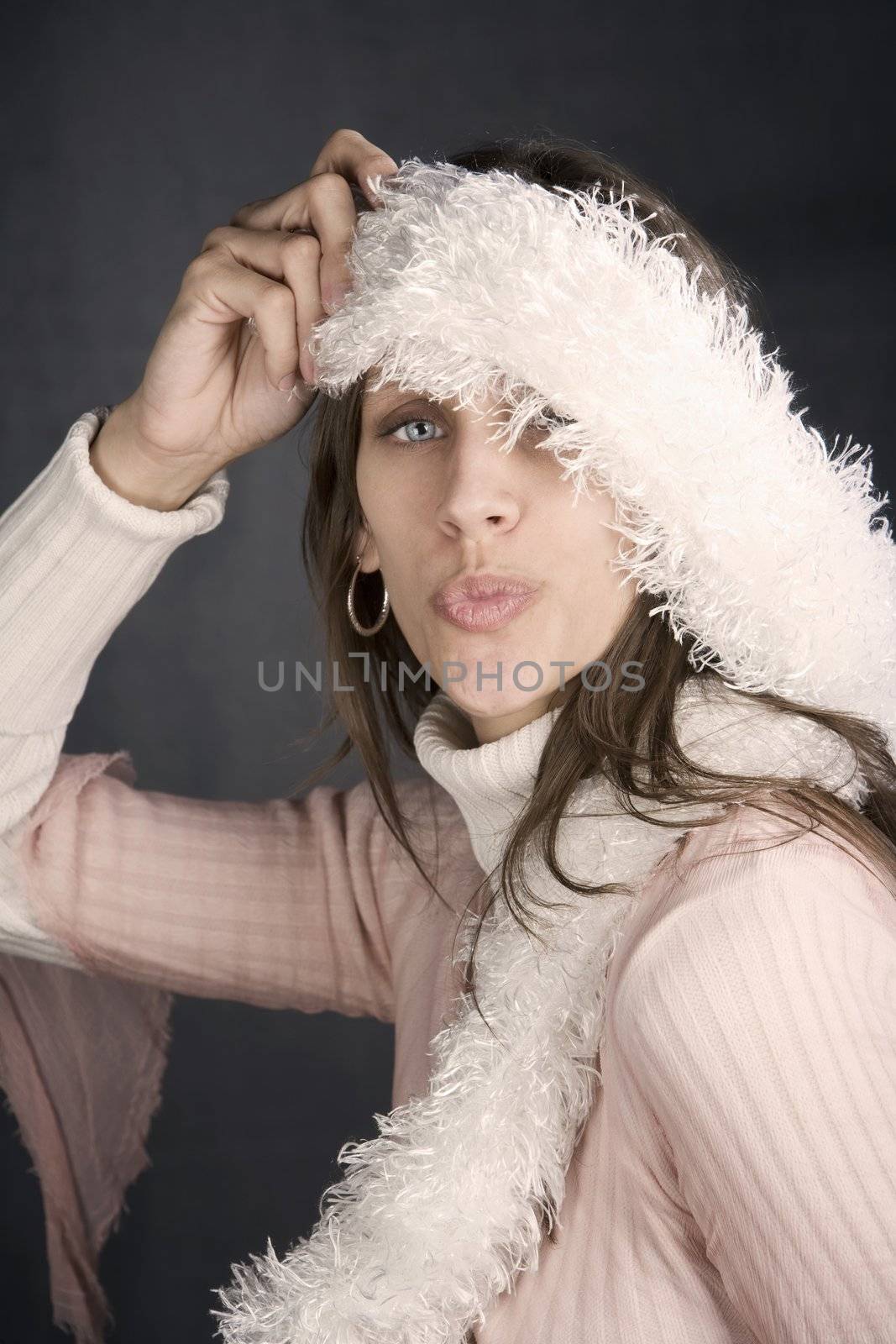 Pretty woman posing with a kiss and a fuzzy scarf