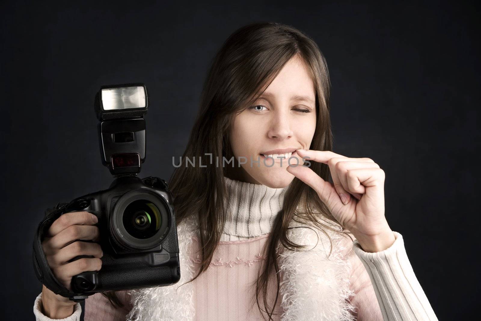 Pretty photographer with a professional camera and flash