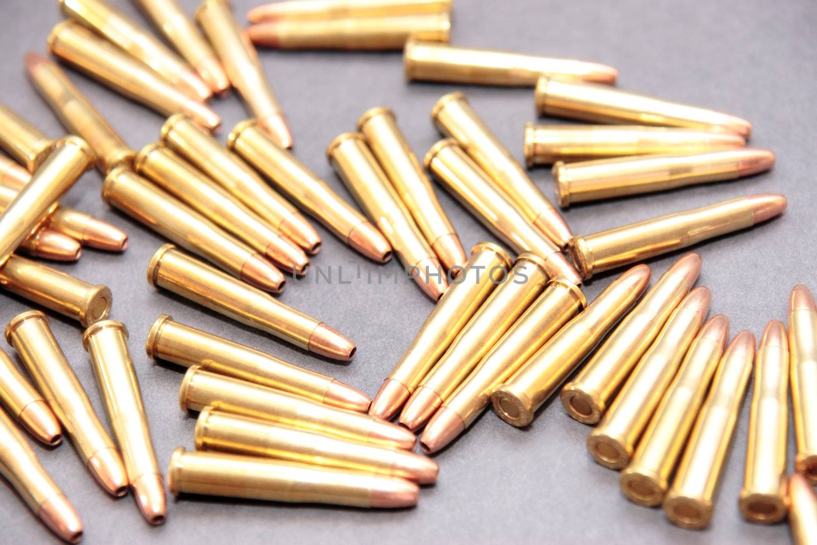 ammunition all in a cluster on a dark background
