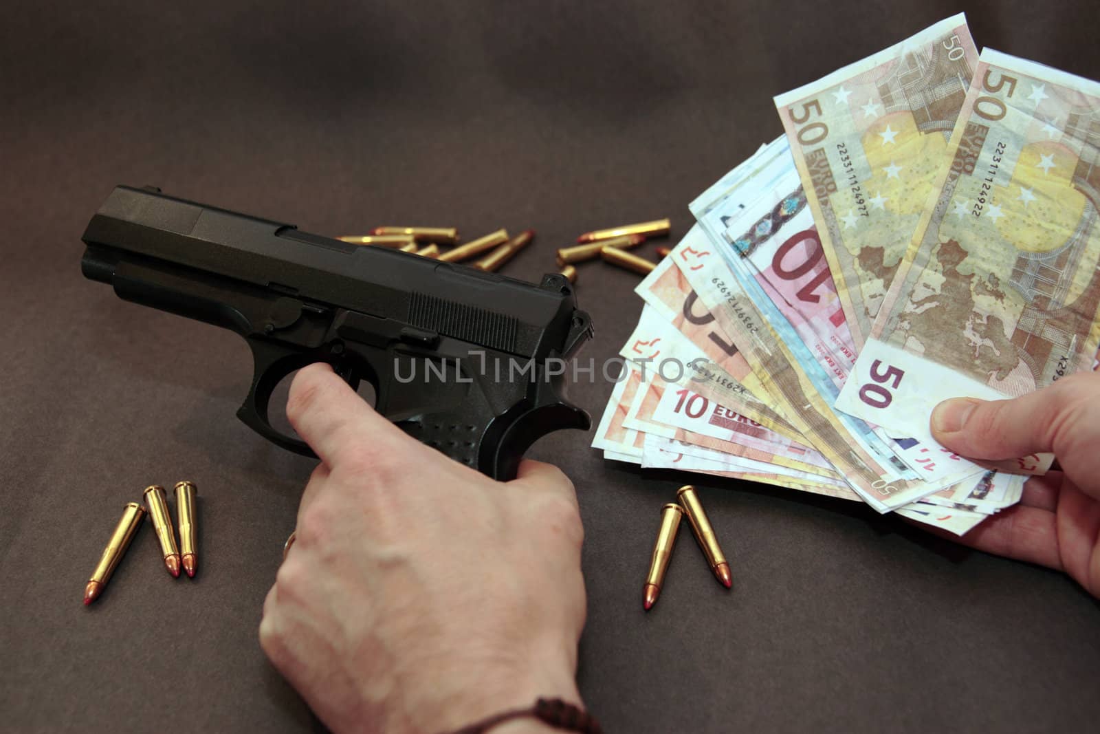 concept of a drug deal or gun hire going down against a dark background