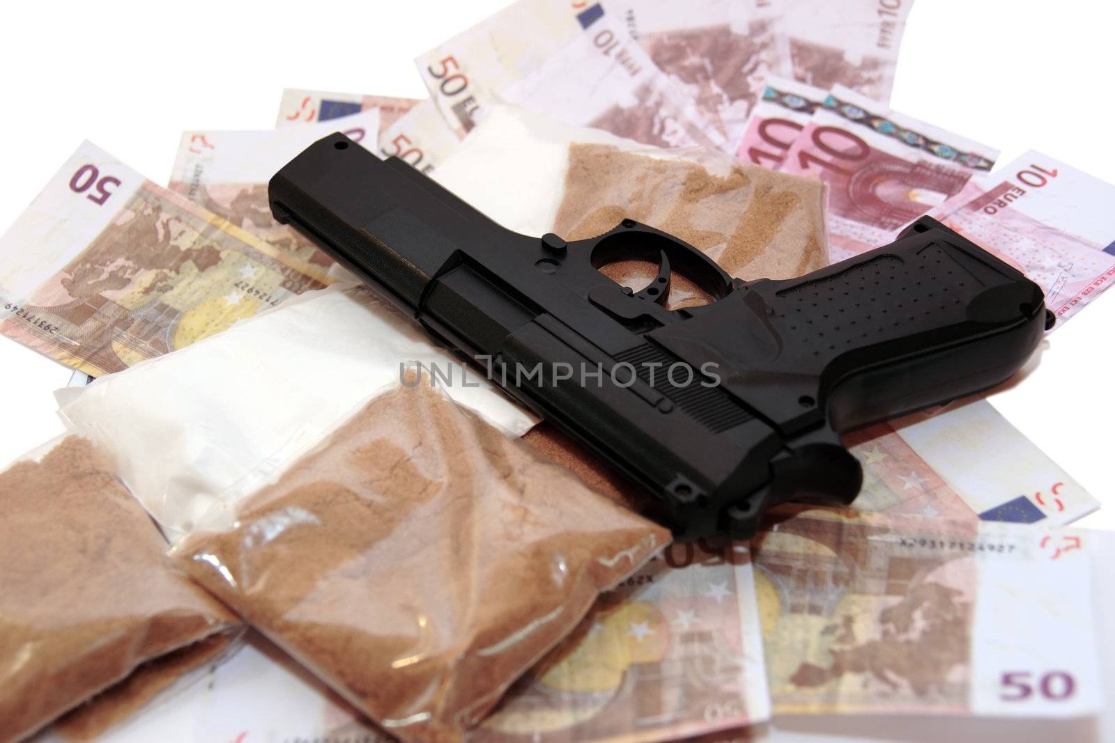 a stash of drugs gun and money showing a dangerous cost to life against a white background