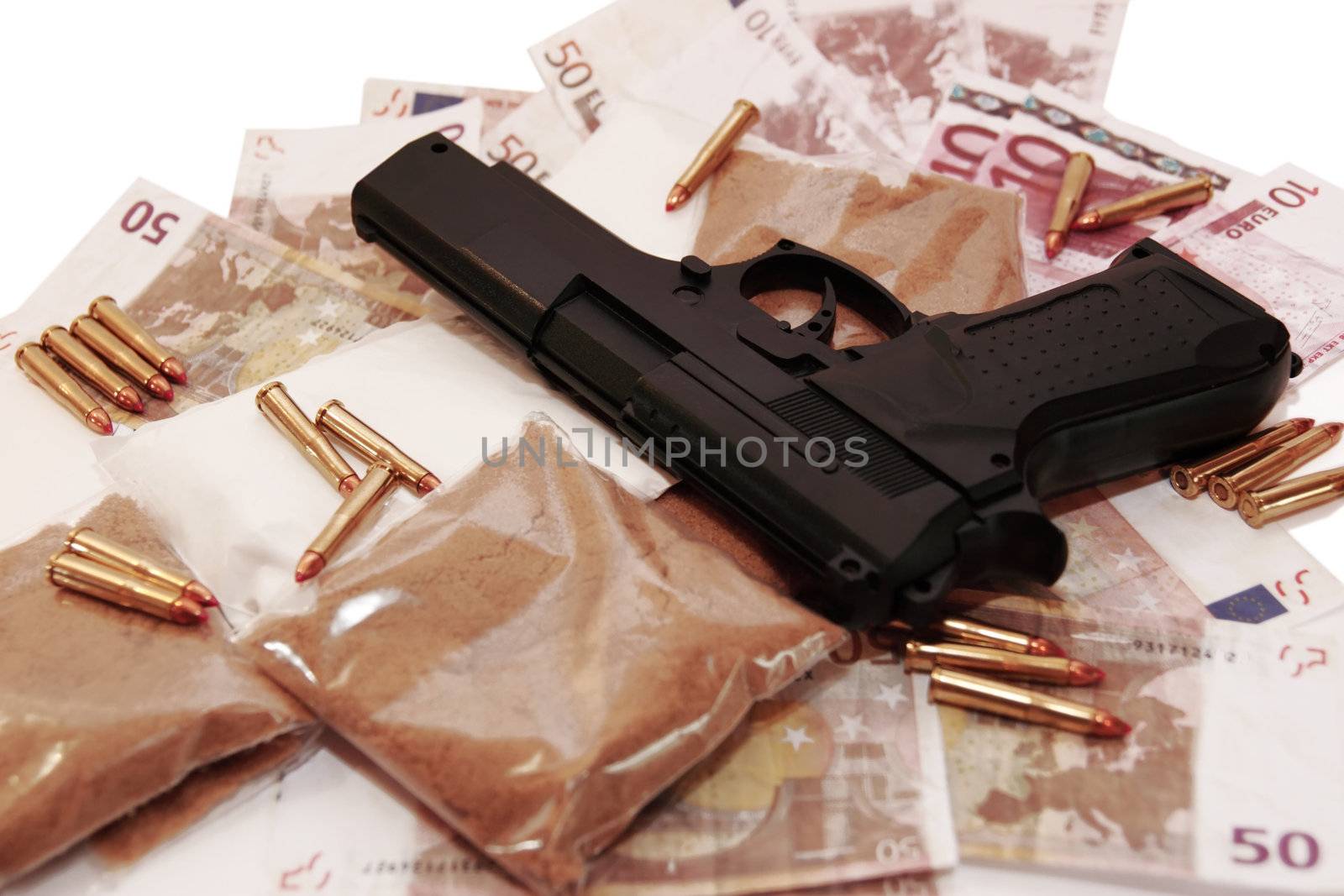 a stash of drugs gun and money showing a dangerous cost to life against a white background