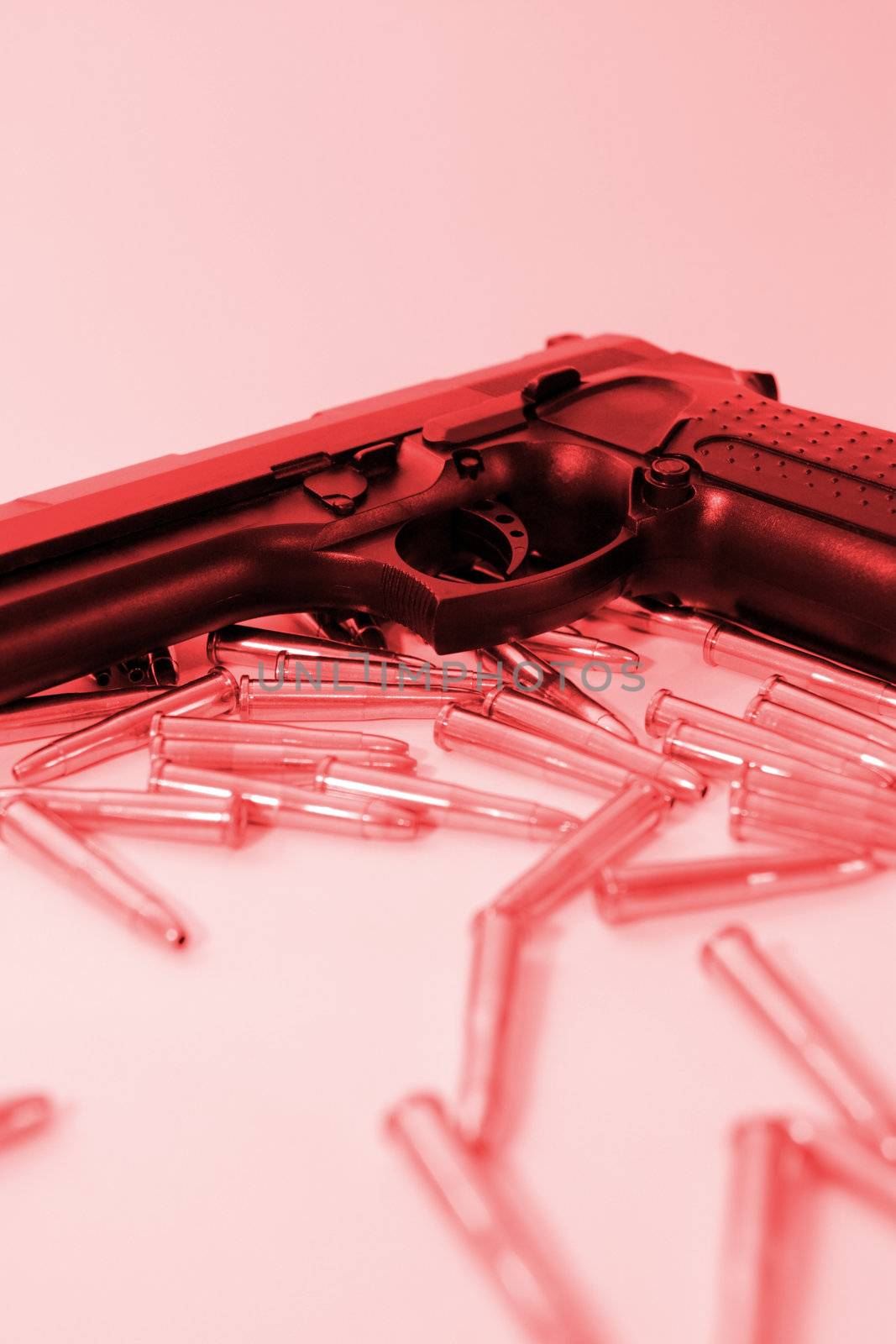 ammo and a handgun on a red background depicting gun culture