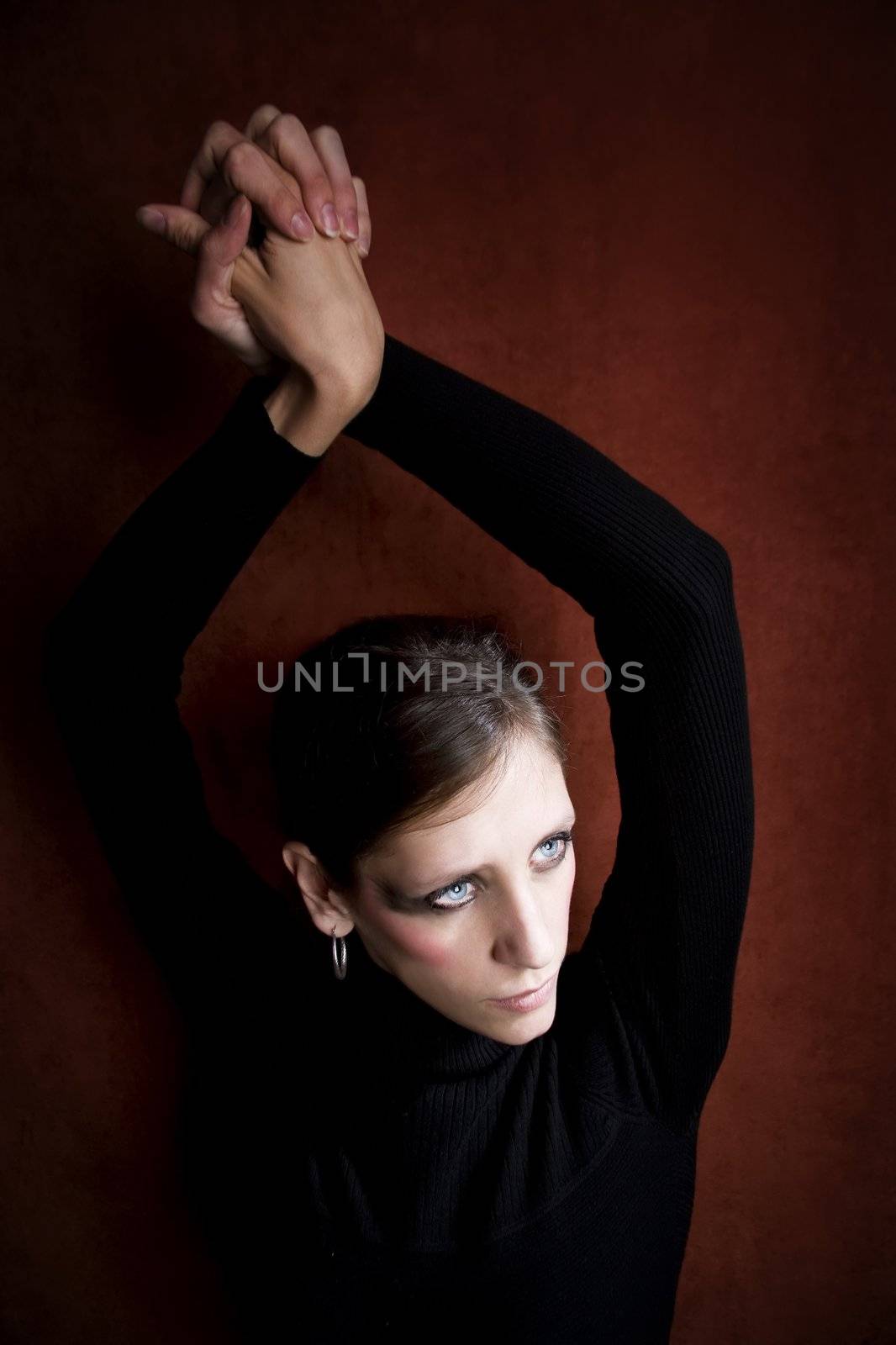 Beautiful Woman with in black hands above her head