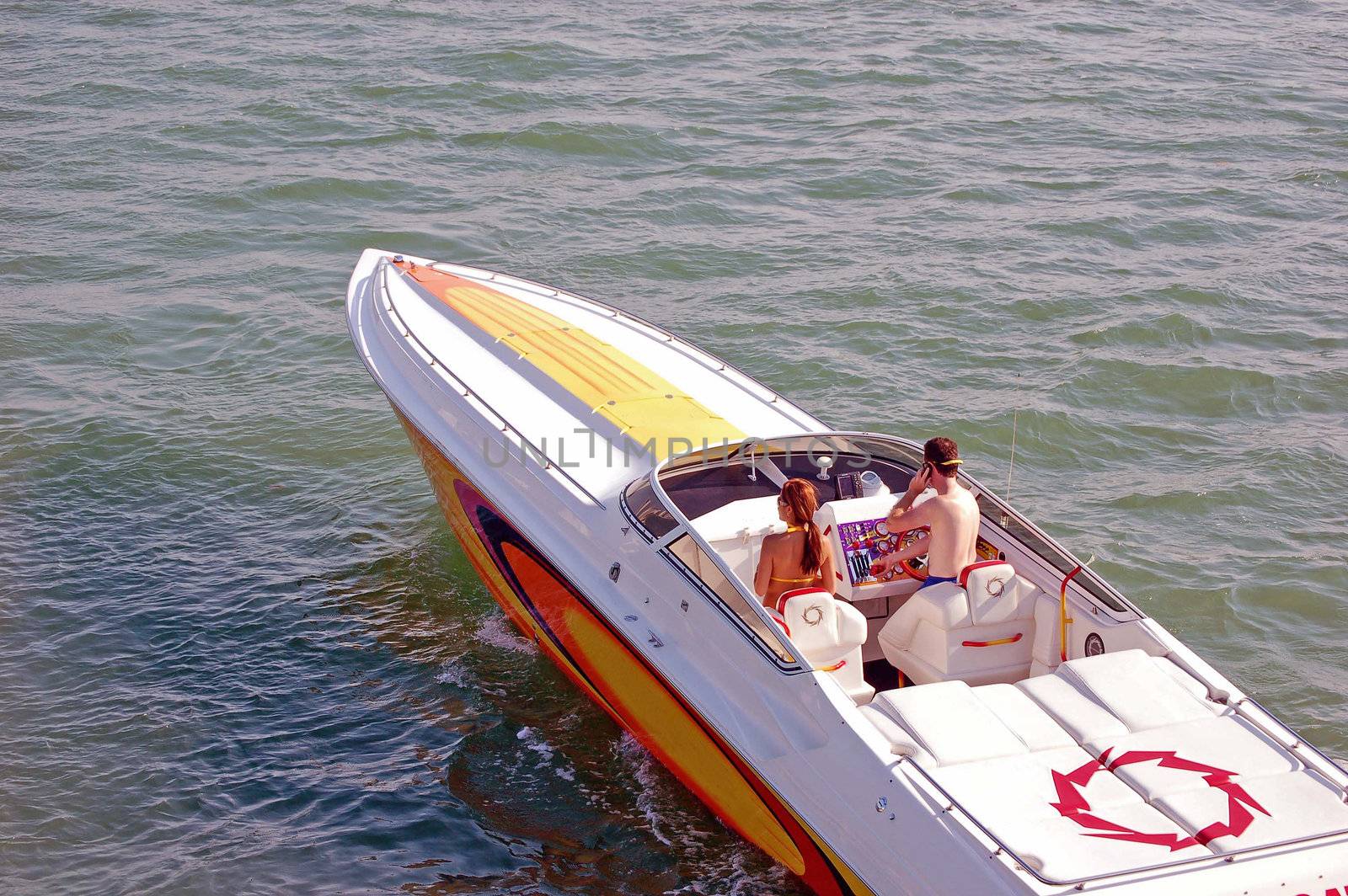 Young couple enjoying a cruise on biscayne bay in a power speed boat