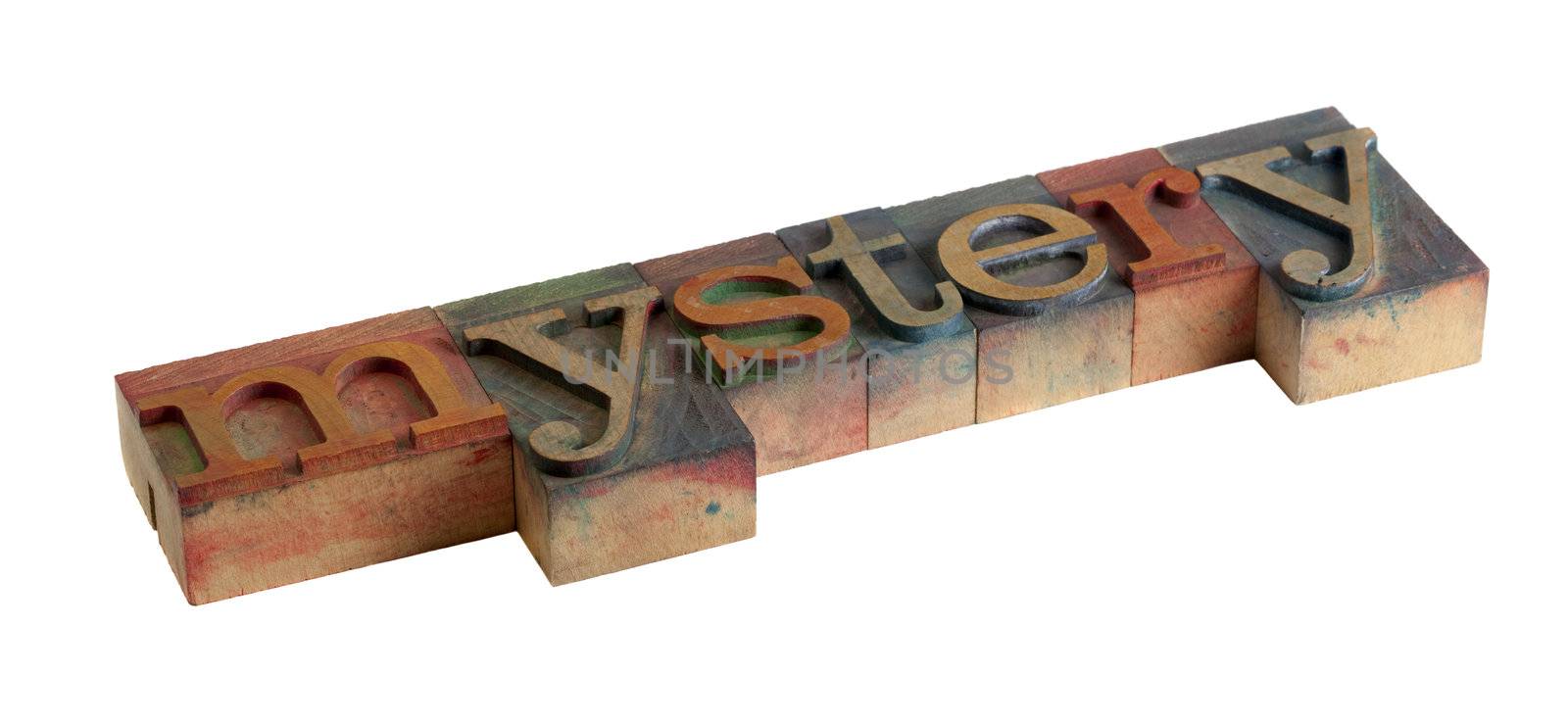 the word mystery in vintage wooden letterpress type blocks, stained by color ink, isolated on white