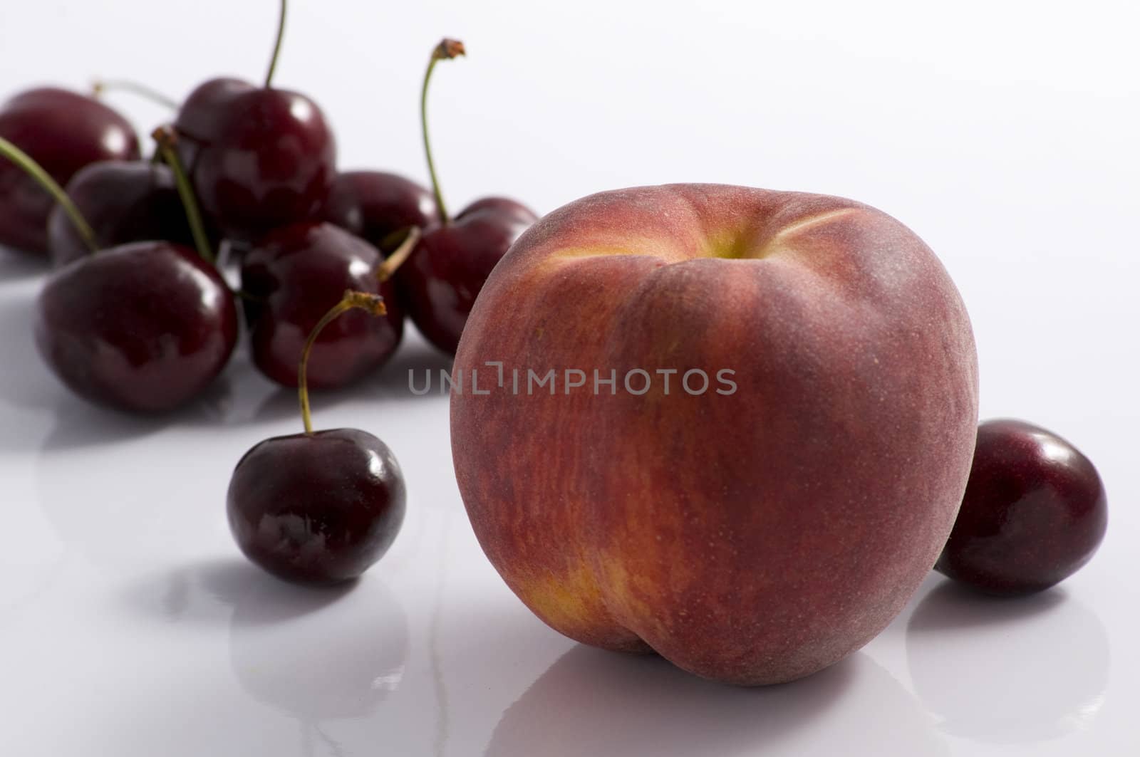 One peach and a cherries group on white background