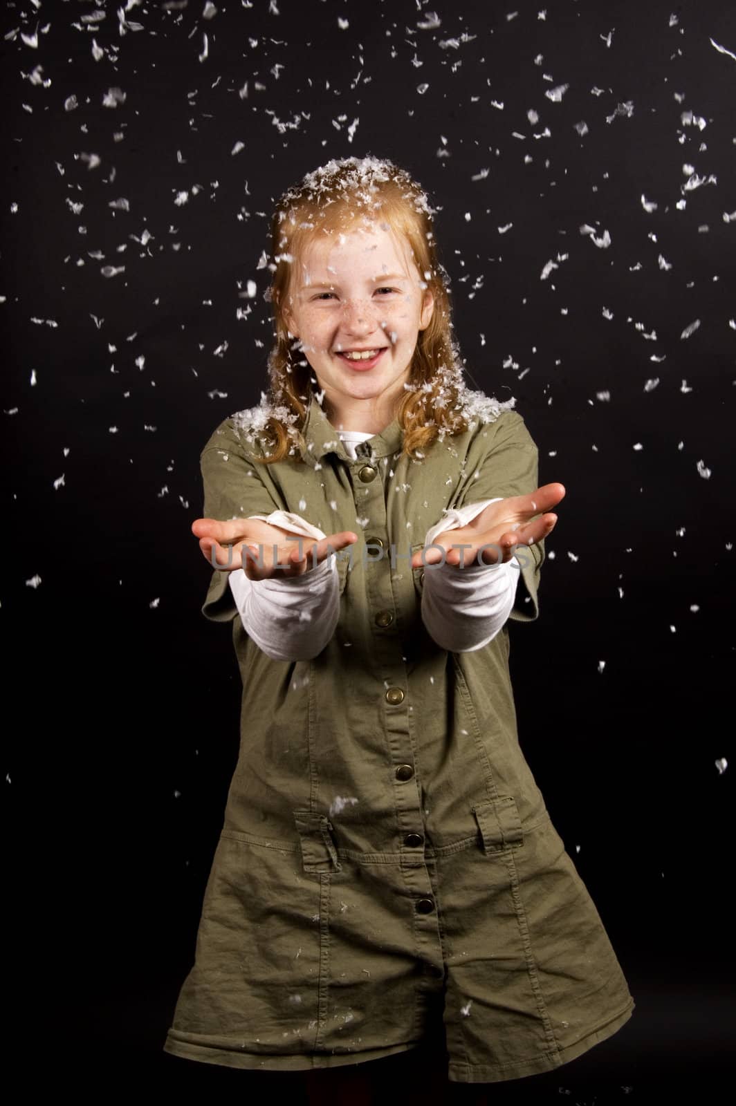 little girl is enjoying the snow on black