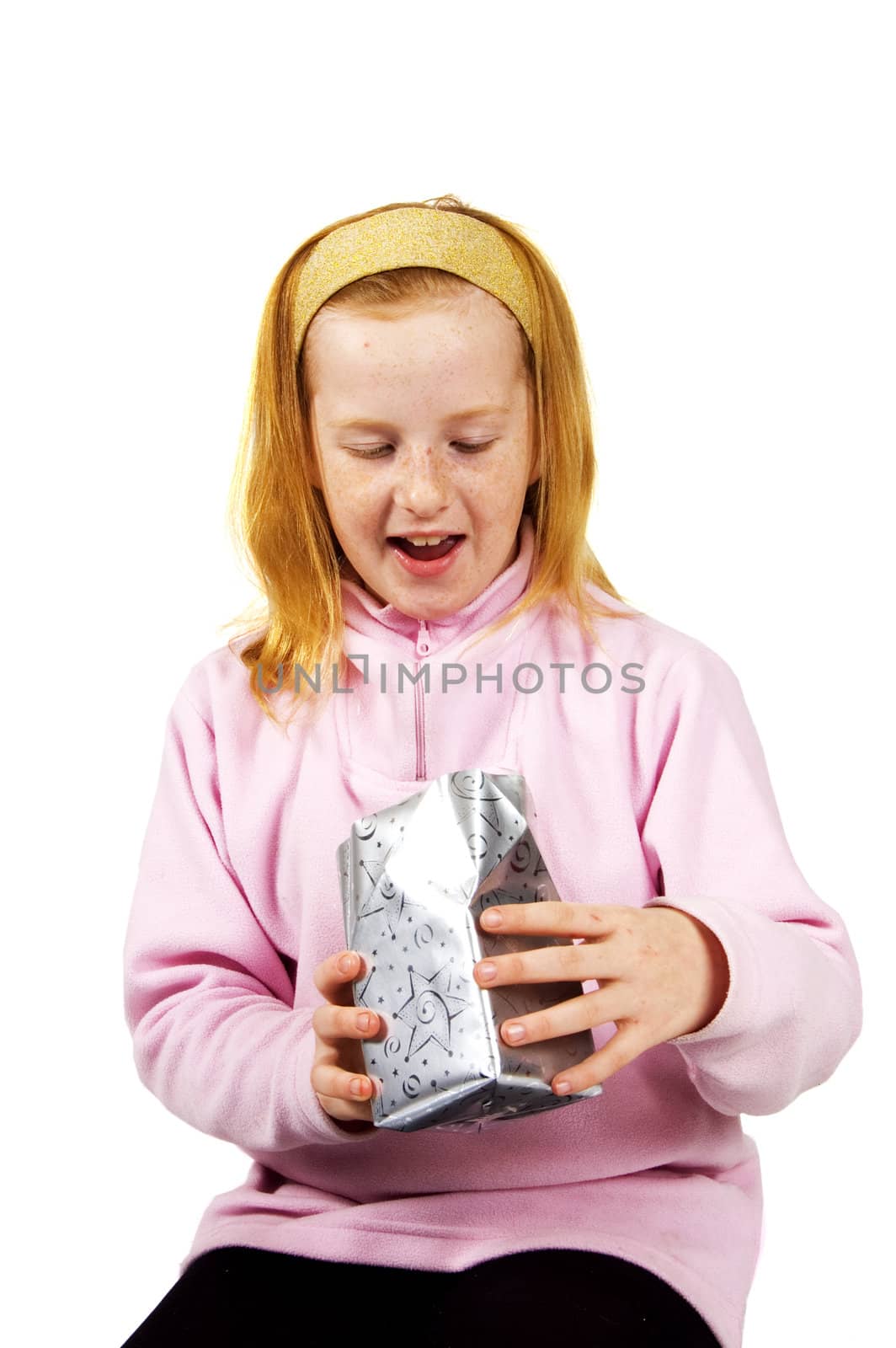 little girl surprised when opening present  on white