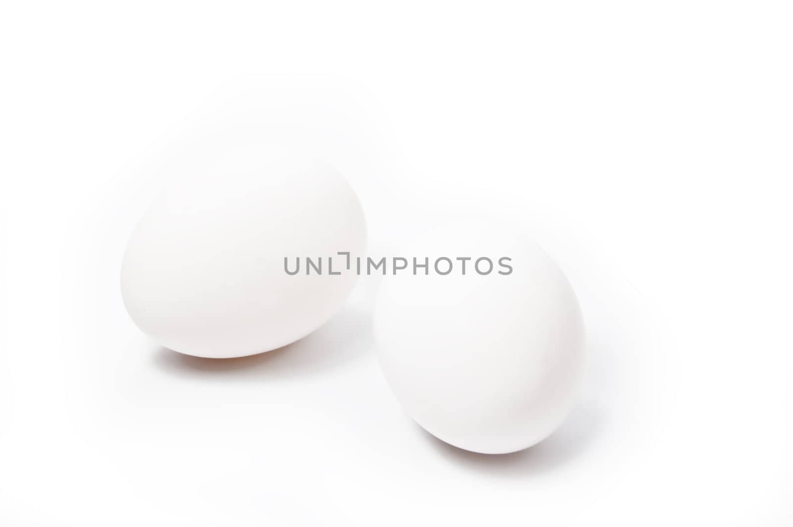 two white oval eggs over white