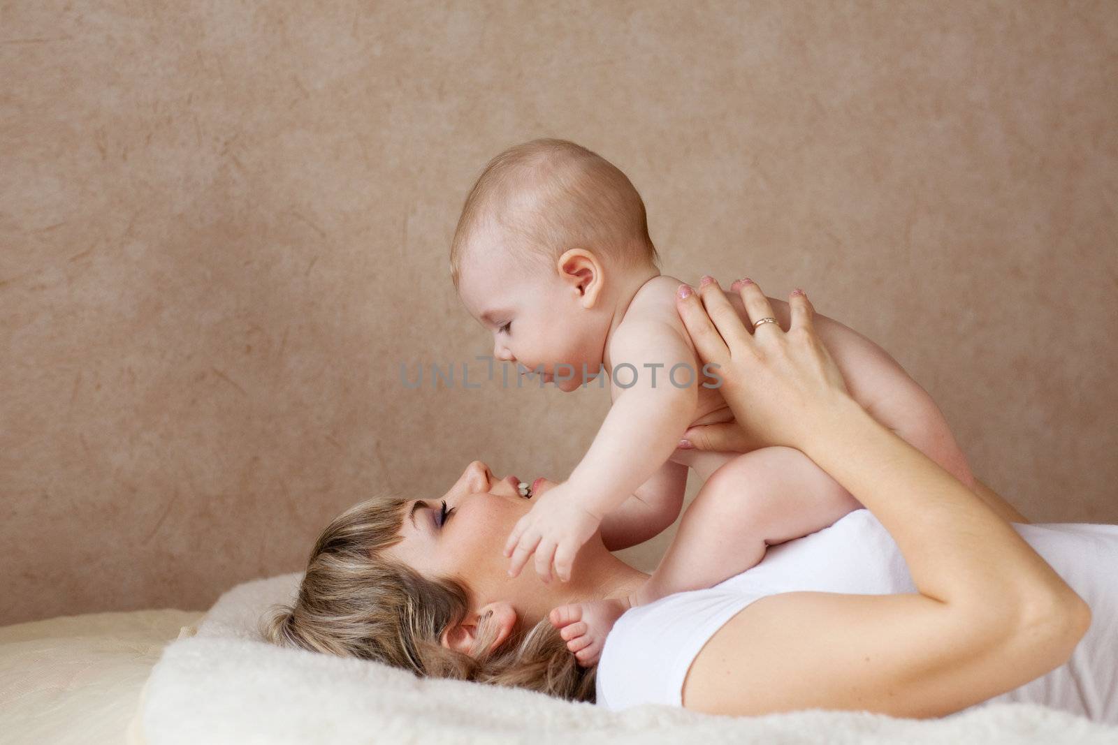 child on the hands of his mom