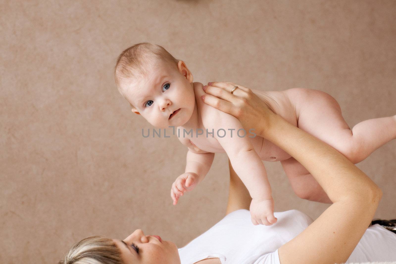 child on the hands of his mom