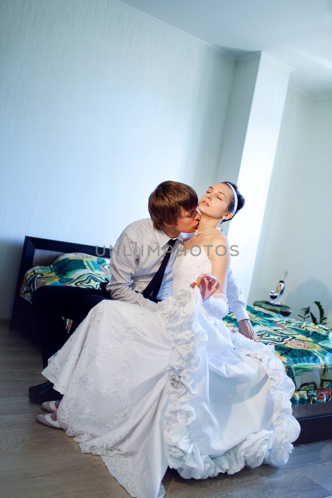 kiss on the bed of bride and groom