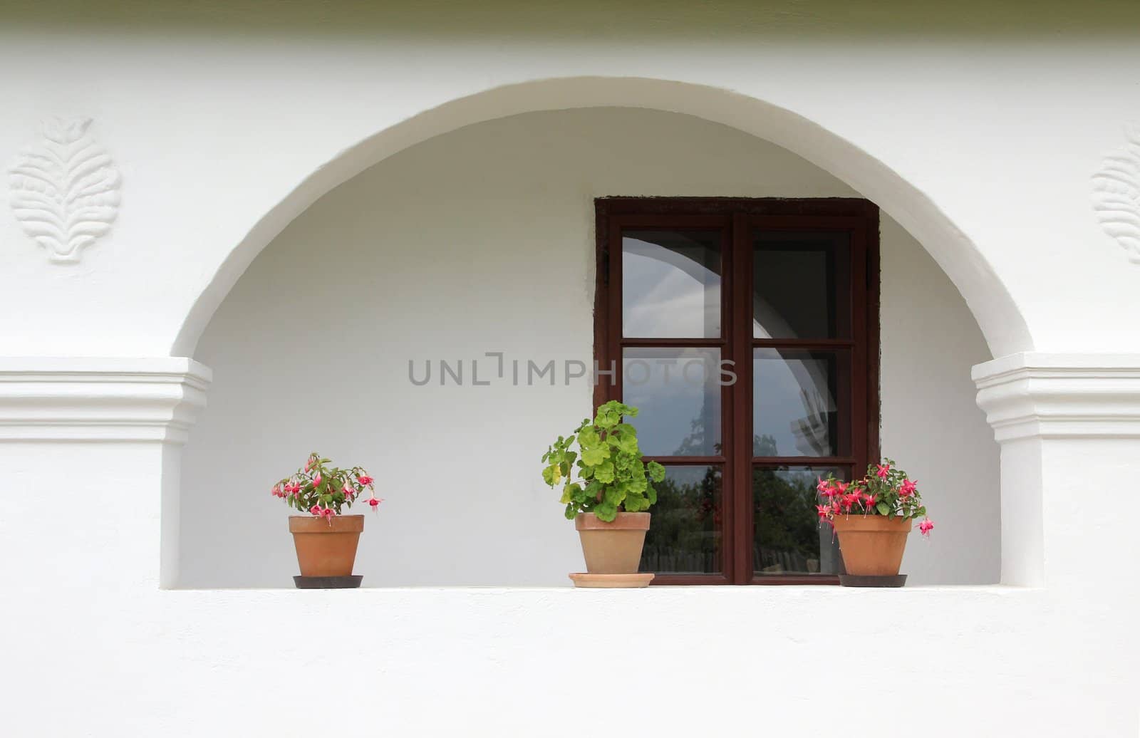 Porch windows and a country house with flowers.