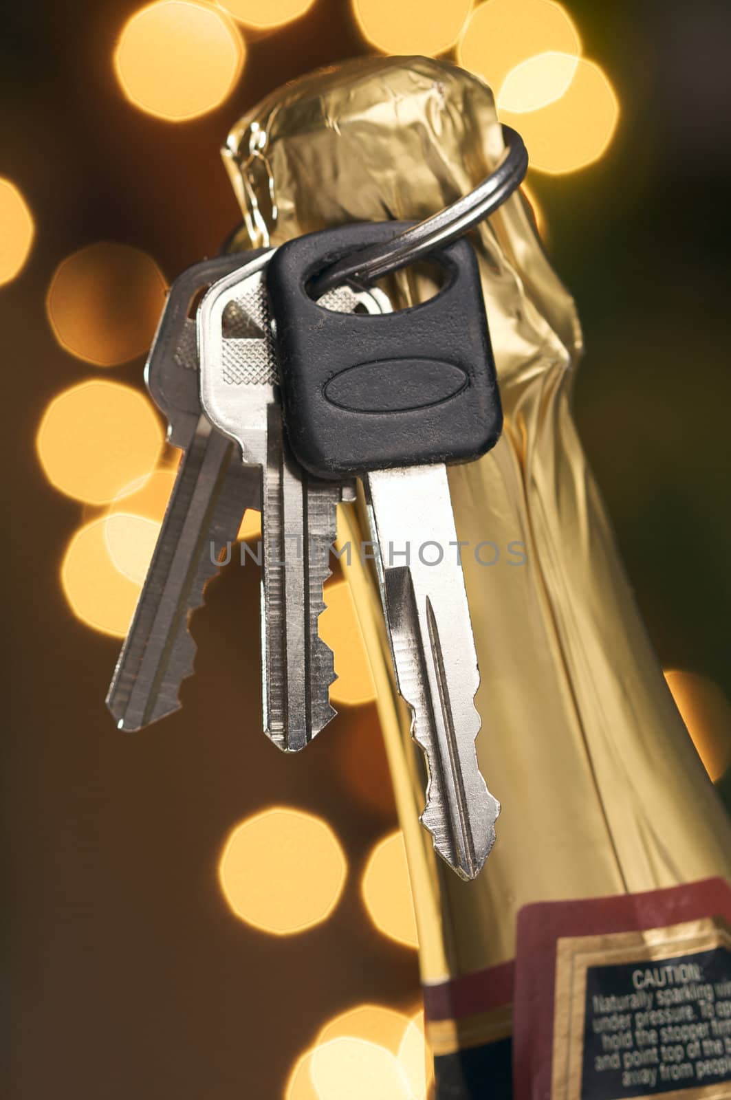 Don't Drink and Drive - Keys and Champagne in Holiday Abstract Background.