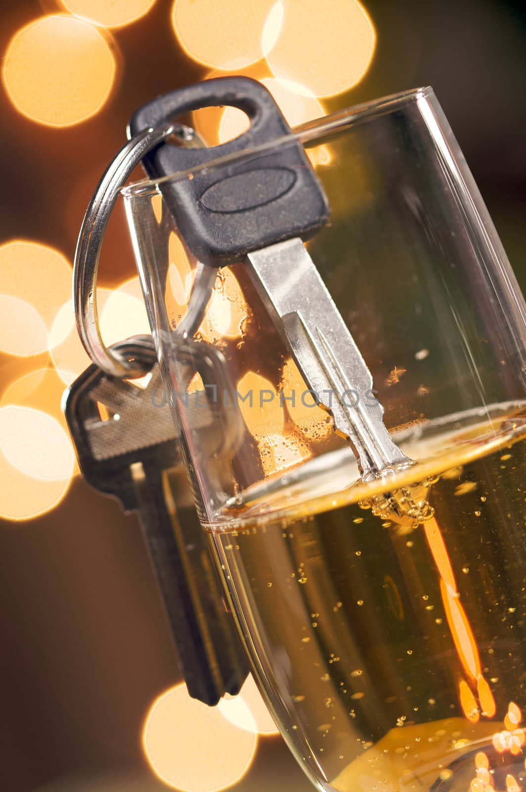 Don't Drink and Drive - Keys and Champagne in Holiday Abstract Background.