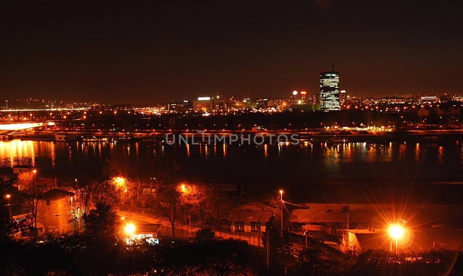 cityscape of night illuminated Belgrade, Serbia over river