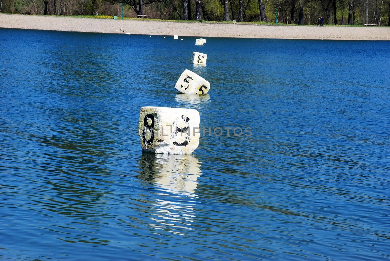 floating white cubes with numbers over blue water