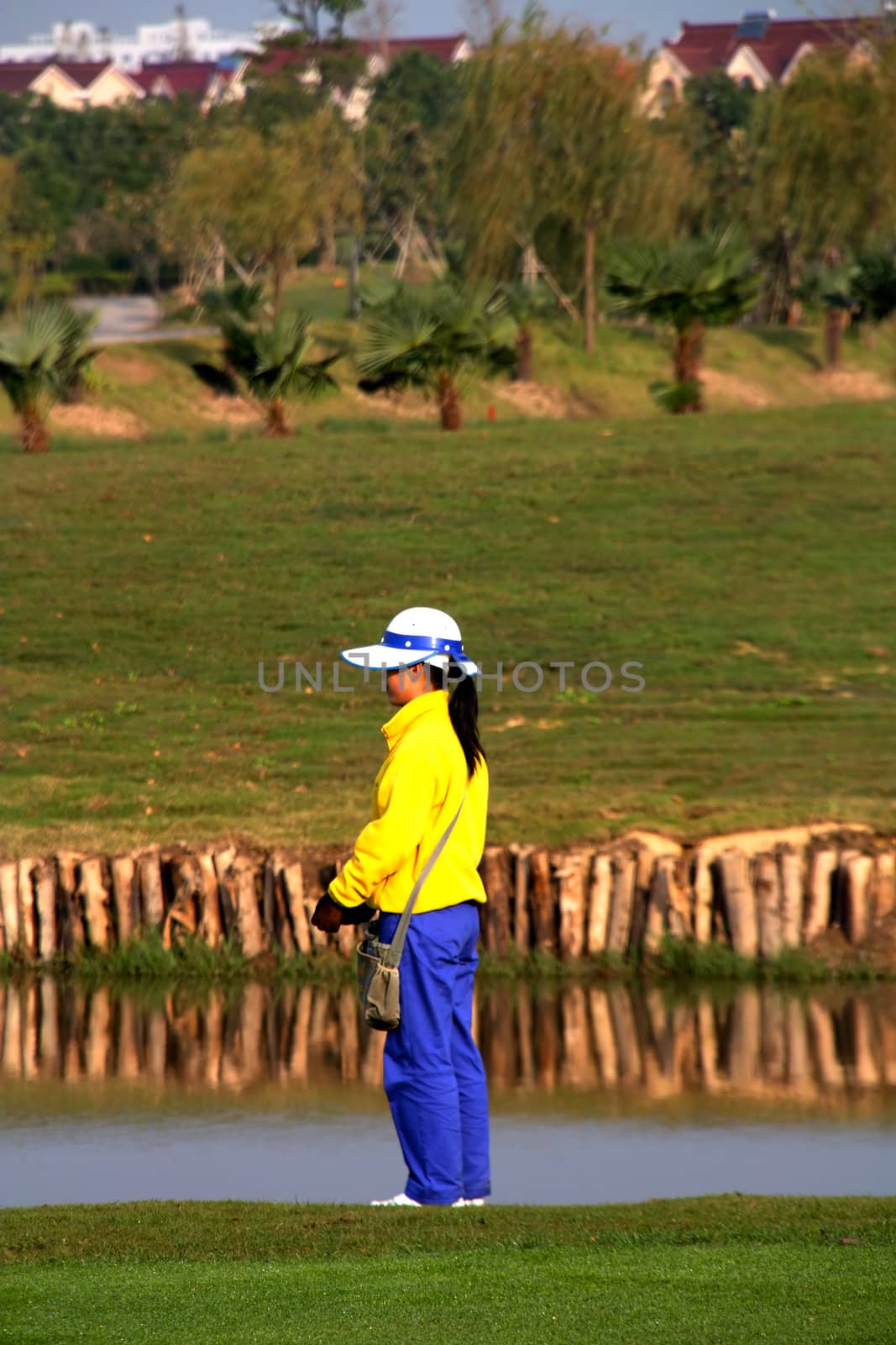 Golf caddie of China waiting for th shot