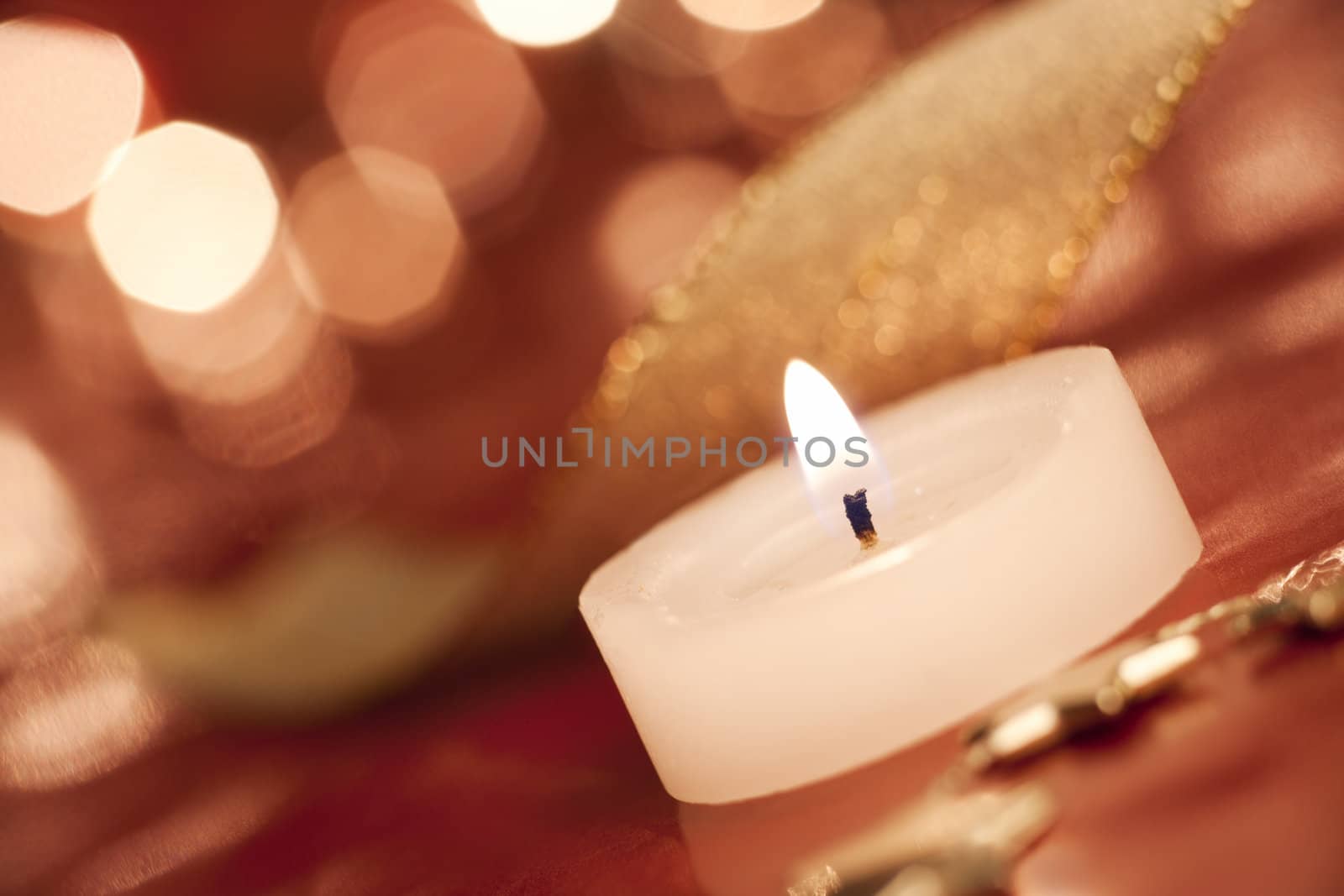 Burning tea light. Shallow depth of field, focus on candle-wick, aRGB.