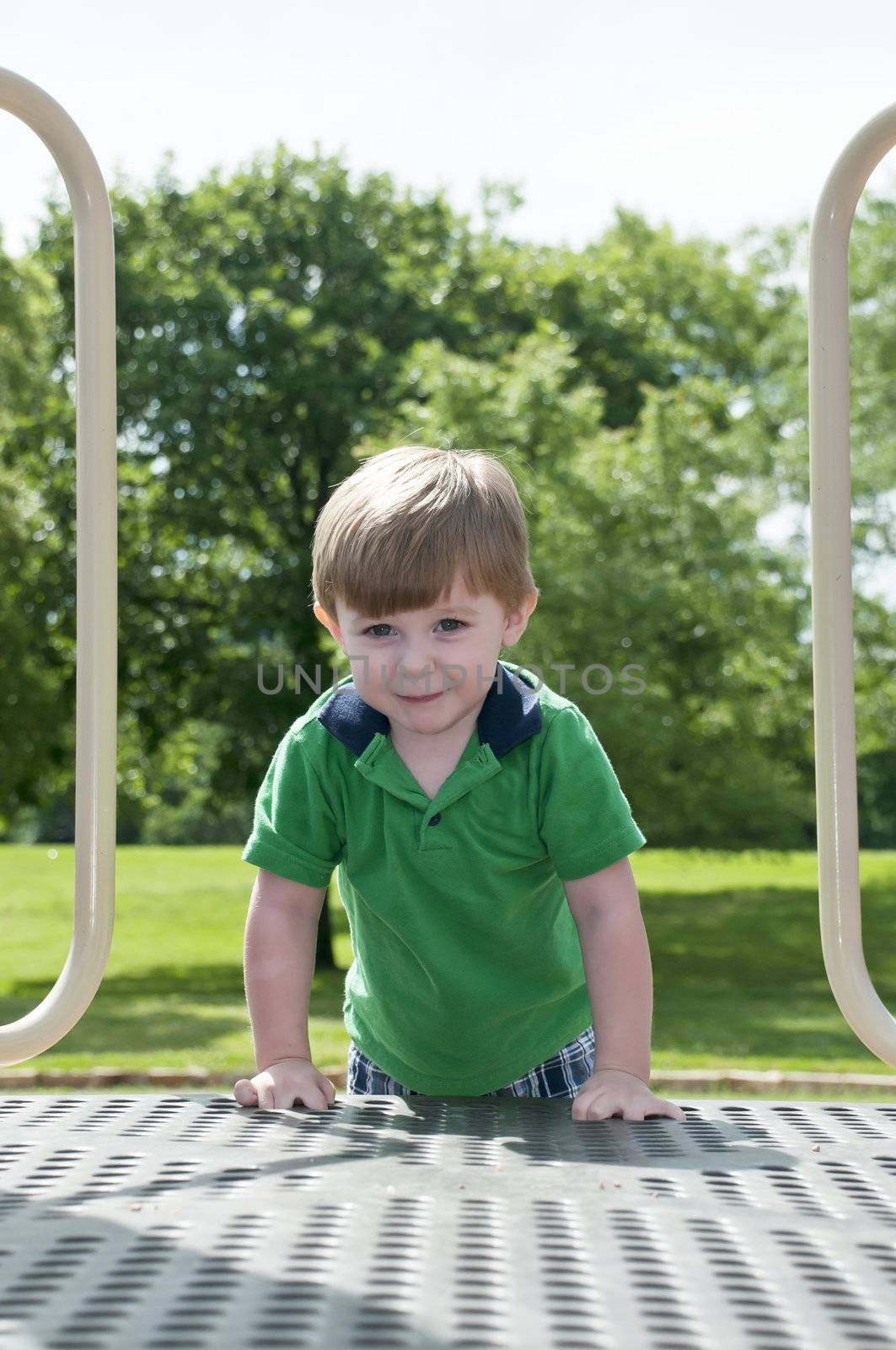 young child having fun and playing in the park on a sunny day