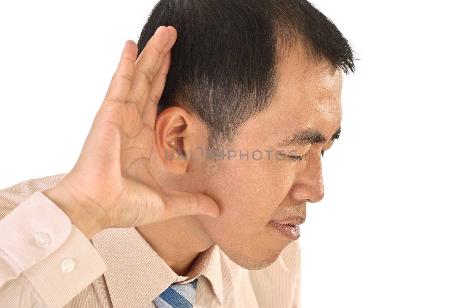 Listen sign with hand on ear, closeup portrait of Asian business man.