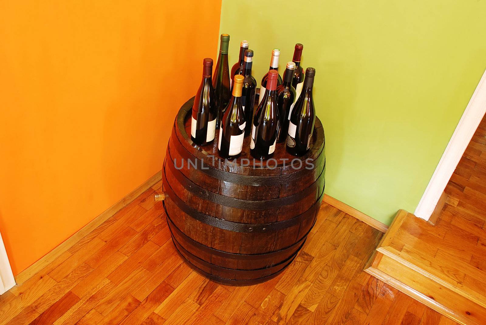 bottles of wine over wooden barrel indoor