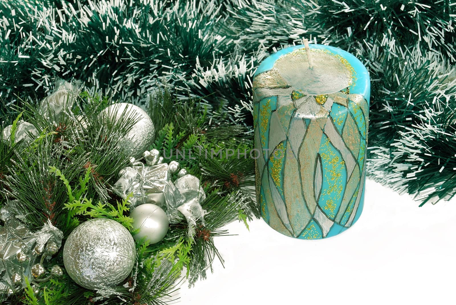 Decorative candle over green new year adorning